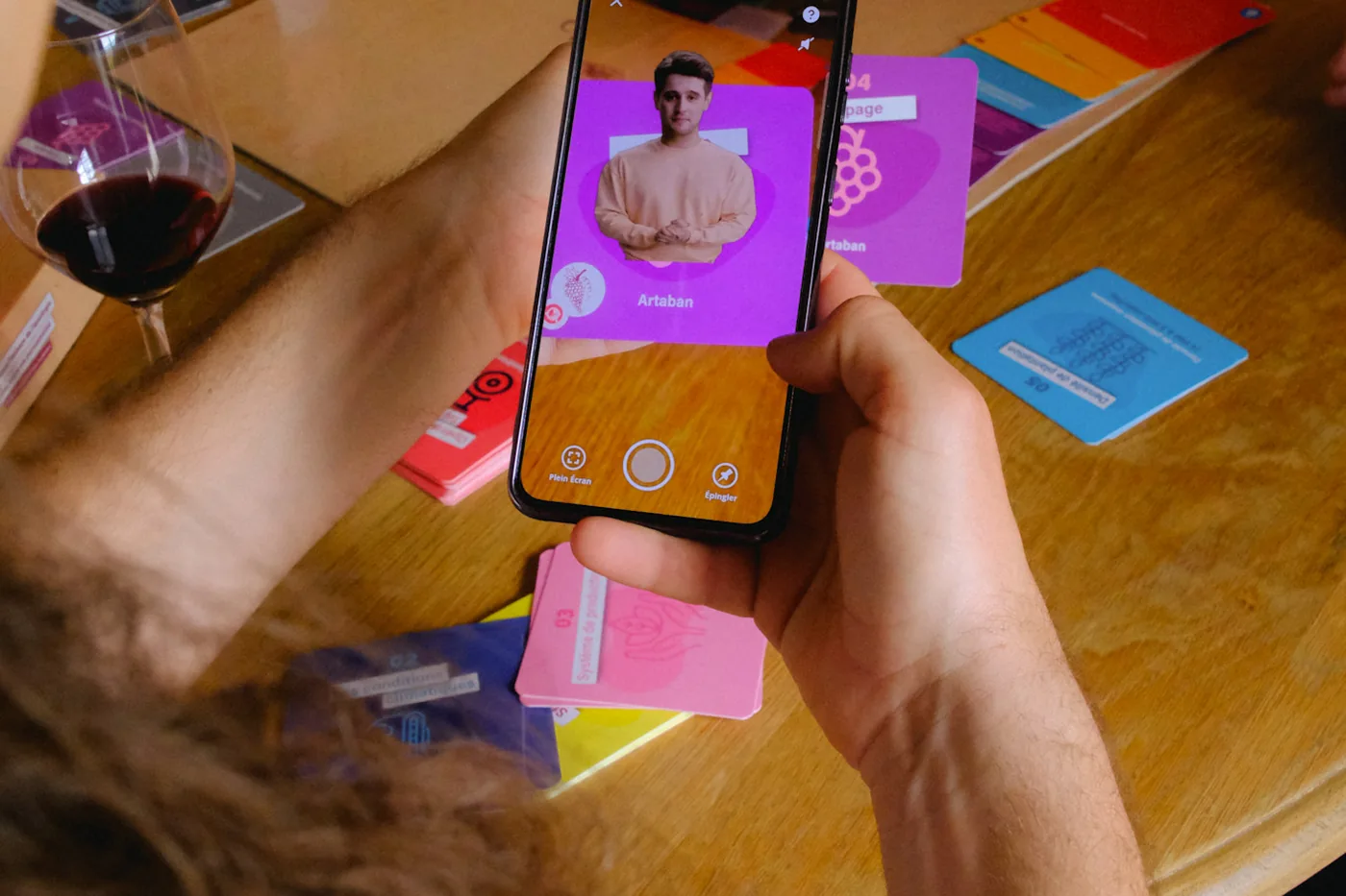 Un smartphone scanne une carte du jeu et ouvre la vidéo de l'application